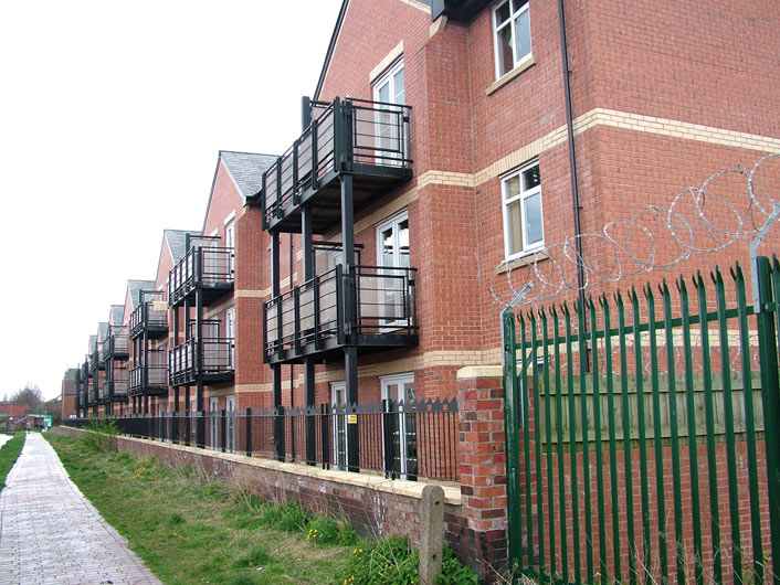 More canalside apartments, note barbed wire