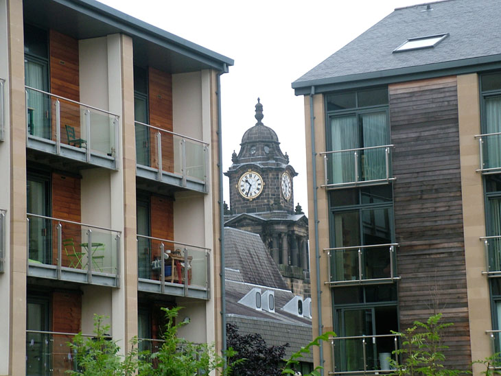 Lancaster Town Hall clock visible between apartment buildings