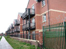 More canalside apartments, note barbed wire More canalside apartments, note barbed wire