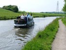 A narrow boat passes us at Daresbury