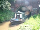 A narrow boat leaves Preston Brook Tunnel