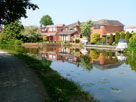 Last houses for a while on a wide stretch of the canal Last houses for a while on a wide stretch of the canal