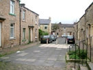 A stone terraced street by the canal A stone terraced street by the canal
