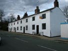 Photo taken from the bus stop, old cottages